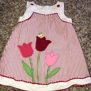 Toddlers red pin stripped dress with floral detail